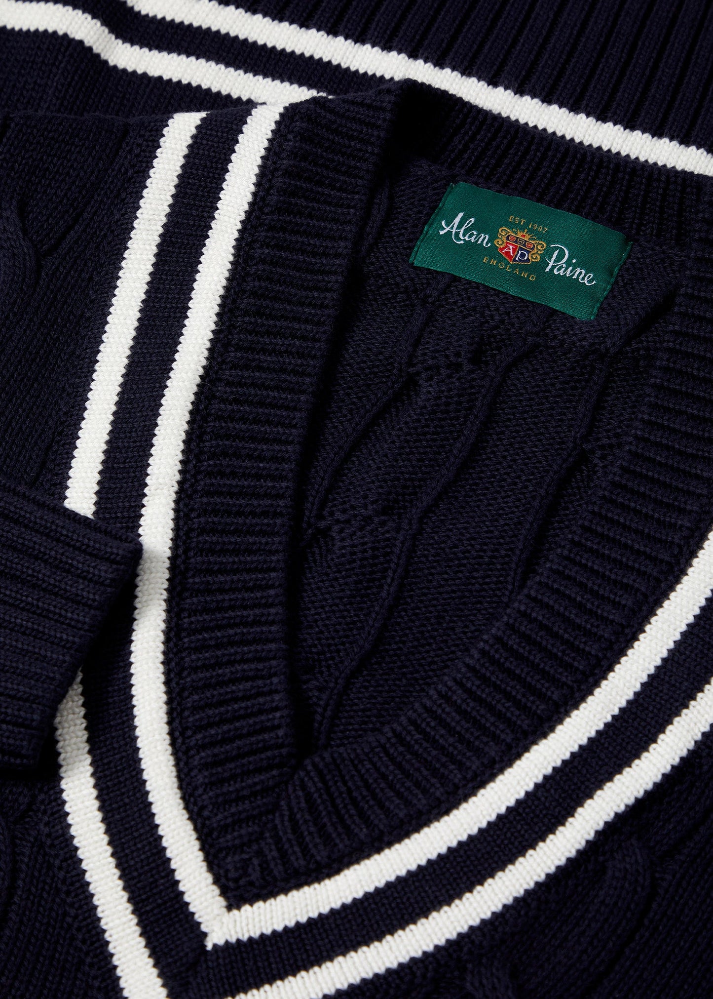 dark navy cable knit cricket jumper with vee neck.